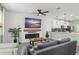 Cozy living room featuring a fireplace, large screen television, and comfortable seating at 11844 Pulitzer Pl, Orlando, FL 32832