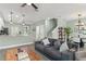 Inviting open-concept living space with modern furnishings, seamlessly connecting to the kitchen and dining areas at 11844 Pulitzer Pl, Orlando, FL 32832