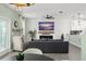 Well-appointed living room with modern design elements, fireplace, and open floor plan to kitchen at 11844 Pulitzer Pl, Orlando, FL 32832