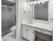 Bathroom featuring vanity with sink and storage, framed mirror, toilet, and glass shower at 120 Mayfair Ct # 120, Sanford, FL 32771