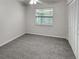 This bedroom features a ceiling fan, window with blinds, fresh carpeting, and a convenient closet at 120 Mayfair Ct # 120, Sanford, FL 32771
