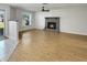 An inviting living room with wood-look floors, a gray brick fireplace, and smooth transitions to a tiled entry way at 120 Mayfair Ct # 120, Sanford, FL 32771
