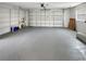 Spacious garage with built-in shelving on the left side, offering ample storage at 120 Mayfair Ct # 120, Sanford, FL 32771