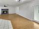 Open concept living room showing the transition between wood-look floors, white tile and access to an outdoor patio at 120 Mayfair Ct # 120, Sanford, FL 32771