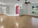 Bright living room showcasing wood-look floors, ceiling fan, and a seamless transition to the kitchen area at 120 Mayfair Ct # 120, Sanford, FL 32771