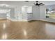 Wood-look flooring, an open concept with a kitchen view, and natural lighting create a welcoming living space at 120 Mayfair Ct # 120, Sanford, FL 32771