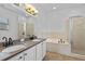 Bathroom showcasing double sinks, a soaking tub, and a glass-enclosed shower at 1380 Normandy Heights Cir, Winter Haven, FL 33880