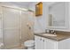 Bathroom featuring a tiled shower, vanity with cabinet and a mirrored wall cabinet at 1380 Normandy Heights Cir, Winter Haven, FL 33880