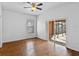 Bedroom with hardwood floors, ceiling fan and sliding doors to screened patio at 1380 Normandy Heights Cir, Winter Haven, FL 33880