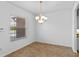 This dining area features neutral tiling, a chandelier, and a window providing natural light at 1380 Normandy Heights Cir, Winter Haven, FL 33880