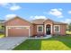 Charming single-story home featuring a two-car garage and well-maintained lawn at 1380 Normandy Heights Cir, Winter Haven, FL 33880