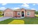 Single story home with two-car garage, neutral paint and manicured lawn at 1380 Normandy Heights Cir, Winter Haven, FL 33880