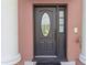 Elegant front door with decorative glass and white column detail at 1380 Normandy Heights Cir, Winter Haven, FL 33880
