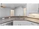 Modern kitchen featuring granite countertops, stainless steel appliances, and a double sink at 1380 Normandy Heights Cir, Winter Haven, FL 33880