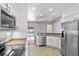 A stylish kitchen with stainless appliances and white cabinets offers views of the pool at 1380 Normandy Heights Cir, Winter Haven, FL 33880