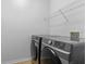 Laundry room with side-by-side washer and dryer and wire rack shelving at 1380 Normandy Heights Cir, Winter Haven, FL 33880