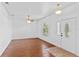 Bright living room featuring hardwood floors, ceiling fan, and natural light at 1380 Normandy Heights Cir, Winter Haven, FL 33880