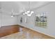 Bright living room features hardwood floors, a modern ceiling fan, and ample natural light from windows at 1380 Normandy Heights Cir, Winter Haven, FL 33880