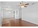 Open-concept living area with hardwood flooring, with ceiling fan and hanging lights at 1380 Normandy Heights Cir, Winter Haven, FL 33880