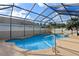 A clear blue pool is enclosed with a screened cage and features a handrail at 1380 Normandy Heights Cir, Winter Haven, FL 33880