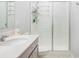 Modern bathroom with a white vanity, updated fixtures, and a glass shower enclosure at 1399 Lassen St, Haines City, FL 33844