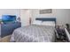 Comfortable bedroom with a stylish patterned bed, a dresser, and relaxing ambiance at 1399 Lassen St, Haines City, FL 33844
