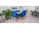 Dining area featuring a wooden table, elegant blue chairs, and stylish decor with natural light at 1399 Lassen St, Haines City, FL 33844