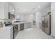 Modern kitchen featuring stainless steel appliances, ample countertop space, and white cabinetry at 1399 Lassen St, Haines City, FL 33844