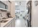 Open concept kitchen area leading to living room with in-unit washer and dryer at 1399 Lassen St, Haines City, FL 33844