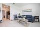 Inviting living room with tile flooring, blue sofa, and a decorative coffee table at 1399 Lassen St, Haines City, FL 33844