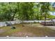Expansive backyard features ample green space, partial fencing, and mature trees for a private setting at 1401 E Voorhis Ave, Deland, FL 32724