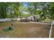 Spacious backyard featuring a deck and partial fencing, perfect for outdoor activities and privacy at 1401 E Voorhis Ave, Deland, FL 32724
