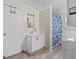 Bathroom/laundry room combo featuring new fixtures, storage and a shower/tub combination at 1401 E Voorhis Ave, Deland, FL 32724