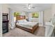 Comfortable bedroom with a large bed, natural light, and arcade game for entertainment at 1401 E Voorhis Ave, Deland, FL 32724