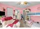 This pink bedroom is spacious and features a bunk bed, storage, and whimsical decor at 1401 E Voorhis Ave, Deland, FL 32724