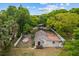 Charming single-story home with a fenced yard, set amidst mature trees for added privacy and appeal at 1401 E Voorhis Ave, Deland, FL 32724