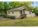 Charming single-story home featuring a cozy front porch, well-maintained lawn, and mature trees at 1401 E Voorhis Ave, Deland, FL 32724