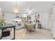 Bright eat-in kitchen features white cabinetry, stainless appliances, tile floors and plenty of storage at 1401 E Voorhis Ave, Deland, FL 32724