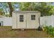 A utility shed in a backyard with lawn, partial fencing, and the ability to store yard equipment at 1401 E Voorhis Ave, Deland, FL 32724
