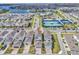 An aerial view of a residential community with homes, amenities, and surrounding natural features at 14317 Lanikai Beach Dr, Orlando, FL 32827