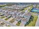 An aerial view of a residential community with homes, streets, and a lake in the background at 14317 Lanikai Beach Dr, Orlando, FL 32827