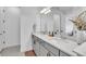 Modern bathroom with dual sinks, gray cabinetry, and decorative accents at 14317 Lanikai Beach Dr, Orlando, FL 32827
