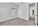 Bright bedroom with a sliding door closet, plush carpeting, and neutral walls at 14317 Lanikai Beach Dr, Orlando, FL 32827
