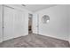 Bedroom with plush carpeting, sliding closet doors, and a circular mirror at 14317 Lanikai Beach Dr, Orlando, FL 32827