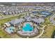 Aerial shot of community pool and recreation center with ample seating, palms and splash pad at 14317 Lanikai Beach Dr, Orlando, FL 32827