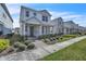 Inviting two-story home featuring a well-manicured lawn and a cozy front porch in a pleasant neighborhood at 14317 Lanikai Beach Dr, Orlando, FL 32827