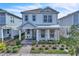 Charming two-story home featuring a welcoming front porch and well-manicured landscaping at 14317 Lanikai Beach Dr, Orlando, FL 32827