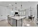Bright, open kitchen area with island and stainless steel appliances leading to living space at 14317 Lanikai Beach Dr, Orlando, FL 32827