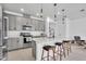 Stylish kitchen with a large island, stainless steel appliances, and contemporary pendant lighting at 14317 Lanikai Beach Dr, Orlando, FL 32827