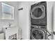 Laundry room with a sink and stacked washer and dryer at 14317 Lanikai Beach Dr, Orlando, FL 32827